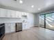 Well-lit kitchen with stainless steel dishwasher and glass sliding door to outdoor space at 2471 Tahoe Cir # 00, Winter Park, FL 32792