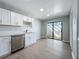 Bright kitchen with stainless steel dishwasher and glass sliding door to outdoor space at 2471 Tahoe Cir # 00, Winter Park, FL 32792