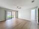 Bright living room features wood flooring, a ceiling fan, sliding glass door, and an open layout at 2471 Tahoe Cir # 00, Winter Park, FL 32792