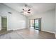 Living room with vaulted ceiling, ceiling fan, and sliding glass doors to the outside at 2471 Tahoe Cir # 00, Winter Park, FL 32792