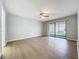 Bright living room with wood flooring, ceiling fan, and sliding glass doors to the patio at 2471 Tahoe Cir # 00, Winter Park, FL 32792