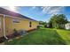 A beautiful backyard with well-maintained lawn and lush landscaping creates a serene outdoor space at 2749 Sand Oak Loop, Apopka, FL 32712
