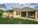 A well maintained backyard featuring a screened lanai and lush green grass at 2749 Sand Oak Loop, Apopka, FL 32712