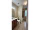 Neutral-toned bathroom featuring a vanity with sink, toilet, and a shower-tub combo with tiled surround at 2749 Sand Oak Loop, Apopka, FL 32712