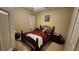 Bedroom with wrought iron bed frame, plaid bedding, and neutral-colored walls at 2749 Sand Oak Loop, Apopka, FL 32712