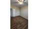Bedroom with wood-look tile flooring and neutral walls, complemented by a ceiling fan and closet at 2749 Sand Oak Loop, Apopka, FL 32712