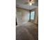 Simple bedroom showing carpeted flooring, neutral walls, a ceiling fan, and two entry doors at 2749 Sand Oak Loop, Apopka, FL 32712