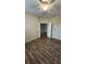 Bedroom with neutral walls, wood-look tile flooring, a ceiling fan, and double door entry to the room at 2749 Sand Oak Loop, Apopka, FL 32712