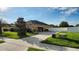 Spacious driveway with side-entry garage and well-manicured lawn, providing ample parking and curb appeal at 2749 Sand Oak Loop, Apopka, FL 32712