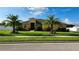Inviting front yard of home featuring lush green grass and mature palm trees under a sunny sky at 2749 Sand Oak Loop, Apopka, FL 32712
