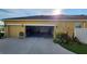 The garage is open and spacious with beautiful landscaping around the exterior, inviting and pristine at 2749 Sand Oak Loop, Apopka, FL 32712