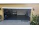 Spacious garage with epoxy flooring, providing ample space for parking and storage at 2749 Sand Oak Loop, Apopka, FL 32712