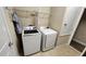 Laundry room featuring a washer and dryer with shelving for storage at 2749 Sand Oak Loop, Apopka, FL 32712