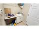 Functional laundry room with sink, cabinet, and counter space, blending utility with efficiency at 2749 Sand Oak Loop, Apopka, FL 32712