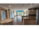 Open-concept living and dining area featuring tile flooring, a blue ceiling accent, and granite countertops at 2749 Sand Oak Loop, Apopka, FL 32712