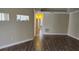 Bright, open living space with wood-look flooring, and a view into the kitchen at 2749 Sand Oak Loop, Apopka, FL 32712