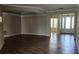 Open living room with wood-look tile, ample natural light, and seamless transition to entryway at 2749 Sand Oak Loop, Apopka, FL 32712
