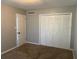 Neutral bedroom with carpeted floors, closet doors, and a door to an adjacent room at 395 Wymore Rd # 200, Altamonte Springs, FL 32714