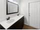 Bathroom featuring double sinks, white countertop and dark cabinets with vinyl wood flooring at 3951 Haynes Cir, Casselberry, FL 32707