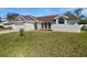 Charming one-story home with a two-car garage, manicured lawn, and a freshly painted white brick exterior at 3951 Haynes Cir, Casselberry, FL 32707