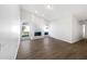 Open living room featuring wood flooring, a decorative fireplace, and lots of natural light at 3951 Haynes Cir, Casselberry, FL 32707