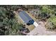 An aerial view of a modern home with a dark roof surrounded by lush greenery at 435 Lincoln Ave, Oviedo, FL 32766