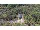 Aerial view shows a secluded home surrounded by dense trees, creating a private, wooded oasis at 435 Lincoln Ave, Oviedo, FL 32766