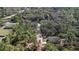 A high-angle aerial shows the home's setting on a wooded lot with a long driveway, offering privacy at 435 Lincoln Ave, Oviedo, FL 32766