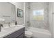 Bathroom featuring stylish vanity, bathtub, and elegant marble tiling at 435 Lincoln Ave, Oviedo, FL 32766