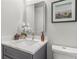 Close-up of bathroom vanity with white countertop and neutral decor at 435 Lincoln Ave, Oviedo, FL 32766