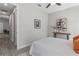 This bedroom features a ceiling fan, decor on the walls, a walk-in closet, and gray flooring at 435 Lincoln Ave, Oviedo, FL 32766