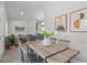 Open-concept dining area with a wood table, flowing into the living room and kitchen at 435 Lincoln Ave, Oviedo, FL 32766