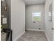 This laundry room has gray flooring, a window for natural light, and utility hookups at 435 Lincoln Ave, Oviedo, FL 32766