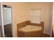 Bathroom with a large tub and window for natural light and privacy at 4964 Luge Ln, Orlando, FL 32839