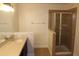 Bathroom with tiled shower, glass doors, vanity and neutral walls at 4964 Luge Ln, Orlando, FL 32839