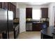 A kitchen shows stainless steel appliances, dark cabinetry and tile flooring at 4964 Luge Ln, Orlando, FL 32839