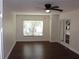 Living room area with dark laminate flooring and natural lighting at 4964 Luge Ln, Orlando, FL 32839