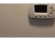 Close-up shot of the thermostat for controlling the climate at 4964 Luge Ln, Orlando, FL 32839