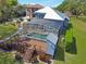 Aerial view of a screened-in pool and well-kept yard offering a perfect outdoor retreat at 5243 W Lake Butler Rd, Windermere, FL 34786