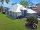 Aerial view of a beautiful waterfront home featuring a metal roof and manicured landscaping at 5243 W Lake Butler Rd, Windermere, FL 34786