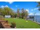 Lush backyard with a wooden deck, storage shed, and a glimpse of the waterfront, creating a serene outdoor space at 5243 W Lake Butler Rd, Windermere, FL 34786