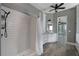 Tiled shower and vanity with granite countertop are visible in this view of the bathroom at 5243 W Lake Butler Rd, Windermere, FL 34786