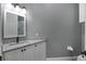 Bathroom vanity with granite counters, white cabinets and black hardware at 5243 W Lake Butler Rd, Windermere, FL 34786