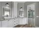 Bathroom showing dual sinks with granite counters and white cabinetry at 5243 W Lake Butler Rd, Windermere, FL 34786