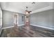 Primary bedroom featuring wood floors and entrances to the bathroom and walk-in closet at 5243 W Lake Butler Rd, Windermere, FL 34786