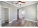 Bedroom with walk-in closet, views to bathroom, and plank floors with white trim at 5243 W Lake Butler Rd, Windermere, FL 34786