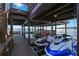 Covered boat dock featuring multiple jet skis, providing ample storage and waterfront enjoyment at 5243 W Lake Butler Rd, Windermere, FL 34786