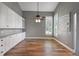 Open dining area with wood floors, built-in cabinets, and a view to the window with shutters at 5243 W Lake Butler Rd, Windermere, FL 34786