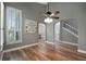 Dining area features wooden floors, shuttered windows, and open view to a staircase at 5243 W Lake Butler Rd, Windermere, FL 34786