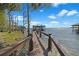 Long wooden dock with railings, leading to the boat house in the water at 5243 W Lake Butler Rd, Windermere, FL 34786